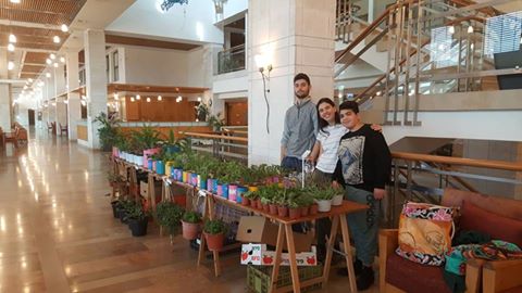 Image may contain: 3 people, people smiling, people standing and indoor